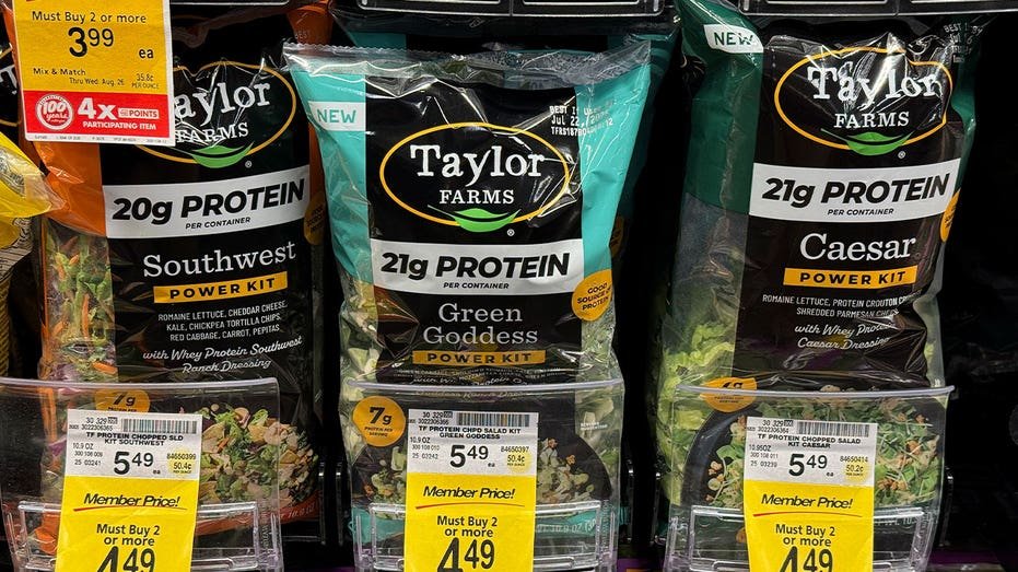 Taylor Farms salad greens displayed on a grocery store shelf at a Safeway location