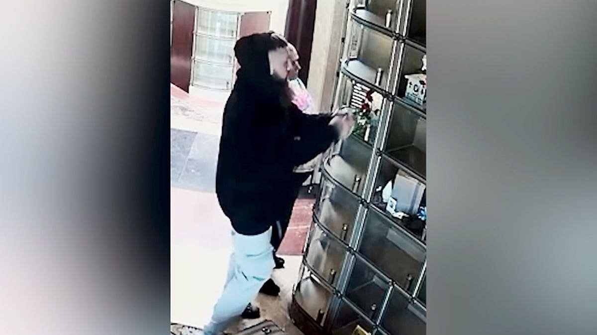 Surveillance footage shows a suspect robbing a mausoleum.