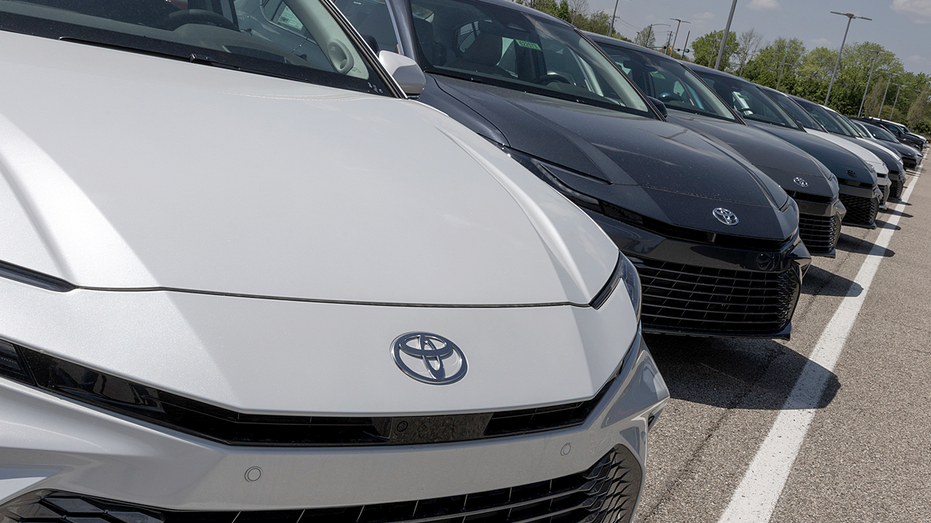 Toyota Camry cars displayed at a dealership.