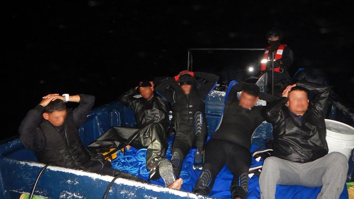 image shows five people with blurred faces in boat