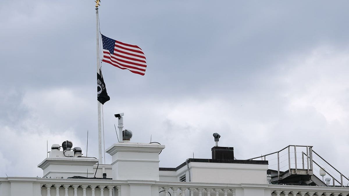 American flag over the White House hangs at half-staff in Washington, D.C.