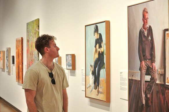 Conor Knight with his 2026 Brisbane Portrait Prize entry, Ruddy Man.