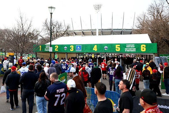 Fans queuing at the temporary entrance to the MCG precinct on Friday.