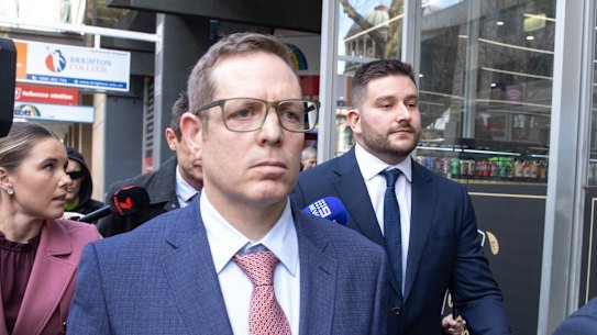 Police officers James Fitzgerald (centre) and Alexander Papanastassis outside court last September.