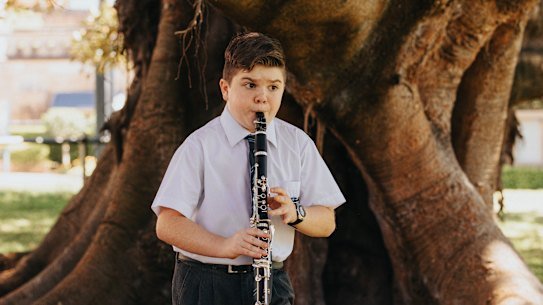 Year 7 student Luca Squire playing his clarinet in the Botanic Gardens, which borders the school.