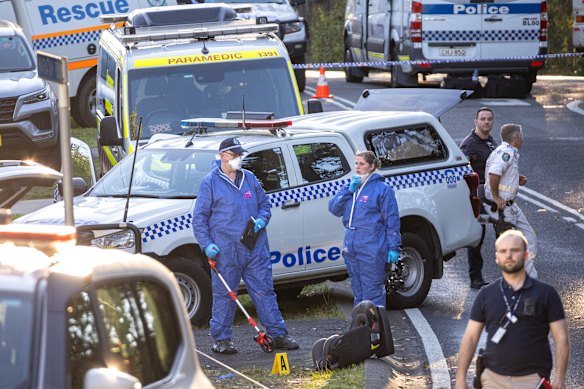 Forensic police place an evidence marker near a child seat at the crime scene in the Blue Mountains on Sunday. Two children were killed in the attack.
