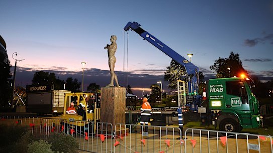 PERTH, AUSTRALIA - JULY 05: The statue of former AFL player Nicky Winmar is removed from outside of Optus Stadium on July 05, 2026 in Perth, Australia. Winmar was last week found guilty of assault in a Victorian Court. (Photo by Paul Kane/Getty Images)