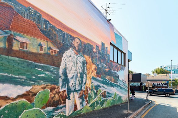 The lane walls are a rotating gallery of murals.