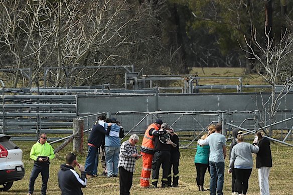 Family and friends console one another on hearing the news that the body of missing bushwalker Lily Hooper had been found.