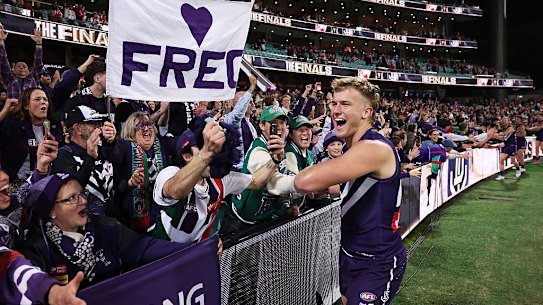Fremantle fans celebrate with Karl Worner after the Dockers defeated Sydney on Friday night.