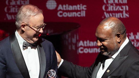 Prime Minister of Papua New Guinea James Marape presents Prime Minister Anthony Albanese with an Atlantic Council Global Citizen Award.