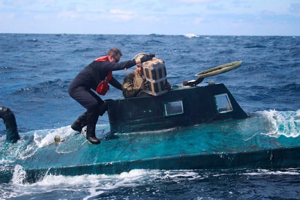 US Coast Guard members board a self-propelled semi-submersible in international waters in 2019. 