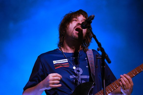 Kevin Parker of Tame Impala performs at the Ball Arena in Denver, Colorado. Parker is wearing a Fremantle Dockers top, but with the logo of major sponsor Woodside covered up.