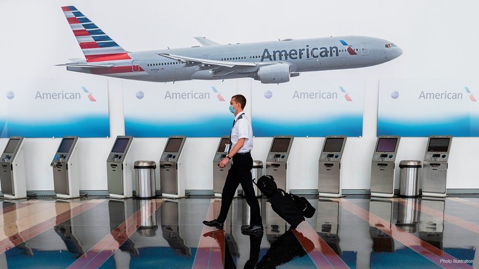 An American Airlines employees walks through an airport.