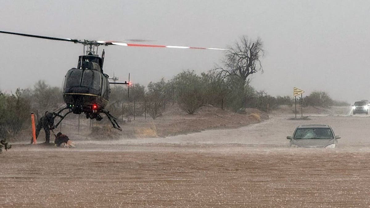 Helicopter conducts rescue of people stuck in stranded vehicle