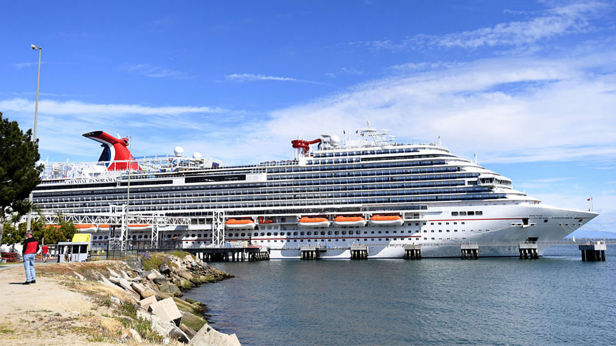 Travelers trying to board the Carnival Panorama cruise ship