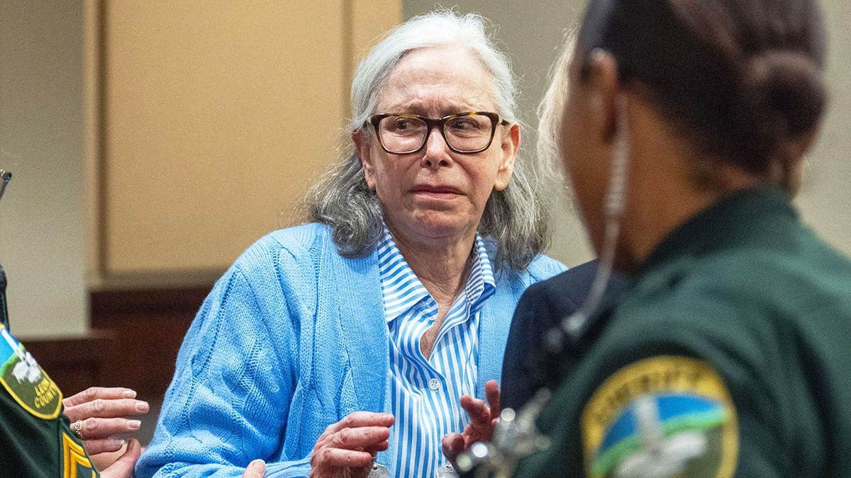 Donna Adelson crying while being escorted by police after being found guilty of murder.