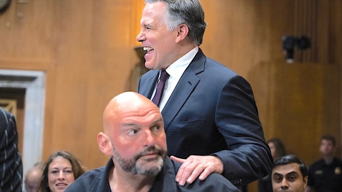 Dave McCormick is laughing and has his hand on John Fetterman