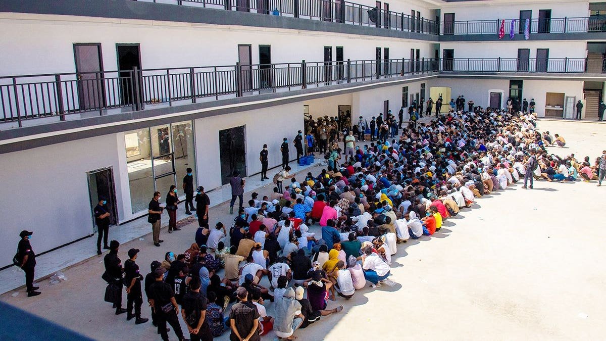 Scam center victims wait in a compound in Myanmar