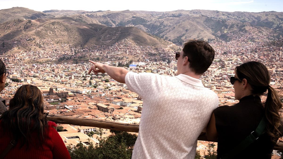 Tourist pointing at landscape in Peru