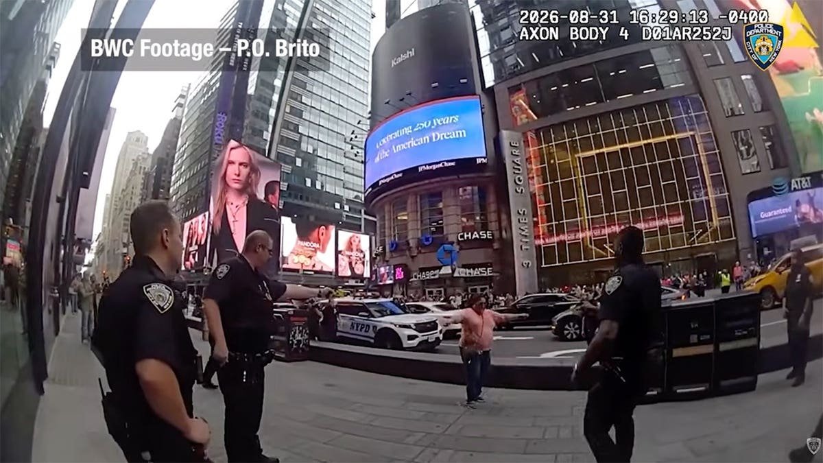 NYPD body camera image shows a woman holding two knives as officers confront her outside One Times Square in Manhattan.