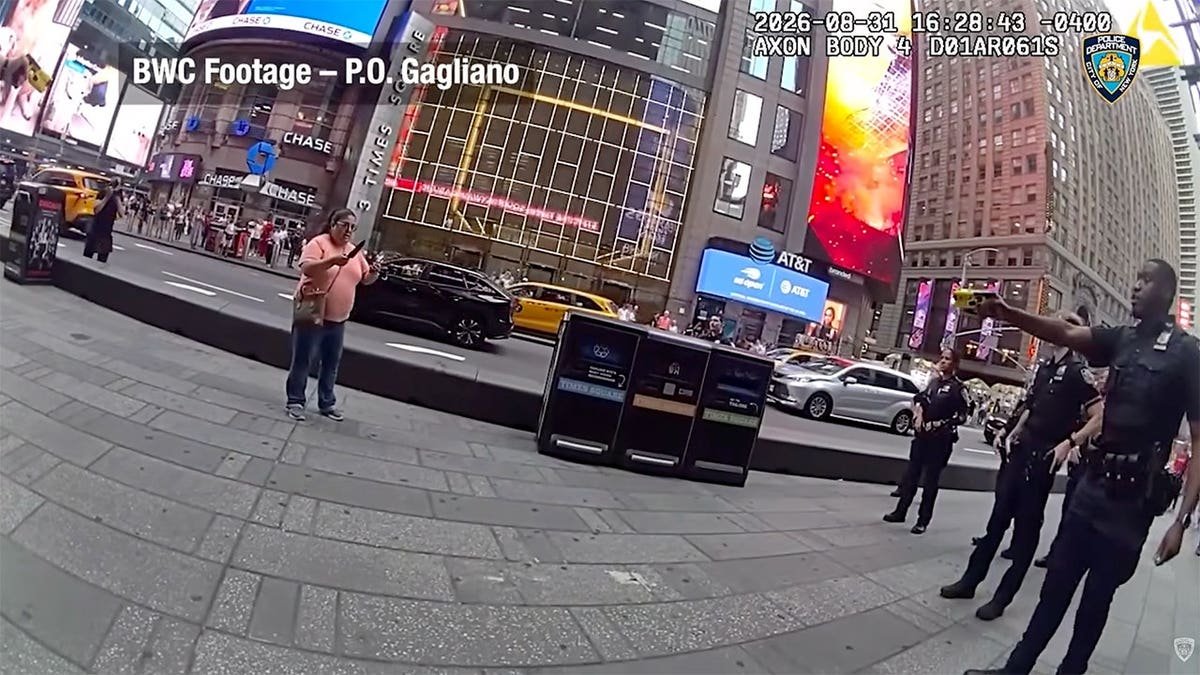 NYPD body camera image shows several officers facing a woman armed with two knives in Times Square.