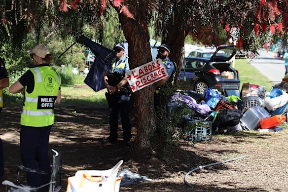 Police and Department of Biodiversity, Conservation and Attractions officers moving through the Memorial Drive encampment.