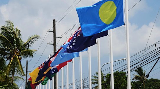 Flags of member states fly outside the summit venue for the Pacific Islands Forum Leaders Meeting in Koror, Palau.