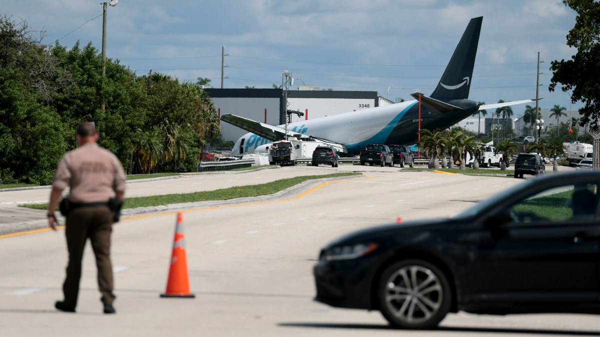 A police officer looks on at the Amazon cargo plane