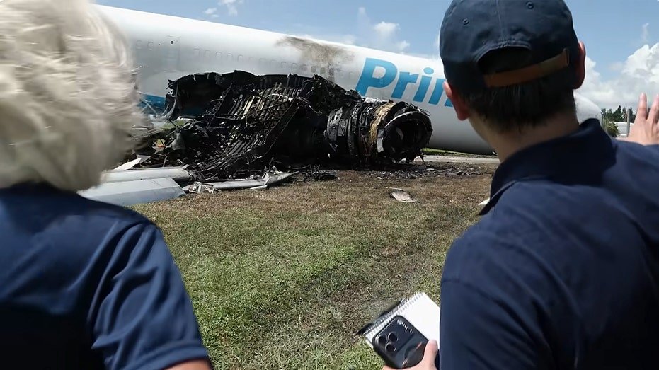 Officials examine charred jet engine