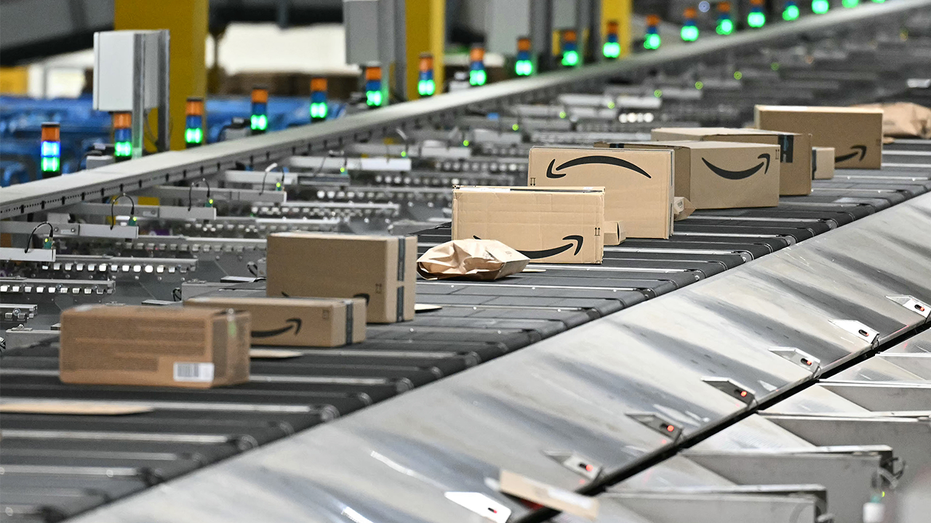 Amazon-branded cardboard boxes travel on an automated conveyor belt system inside Amazon's LCY3 Fulfillment Centre in Dartford, east of London, on June 4, 2026.