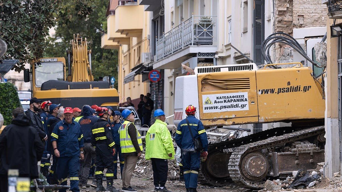 Rescuers work at the scene following a blast in Athens' Plaka district.