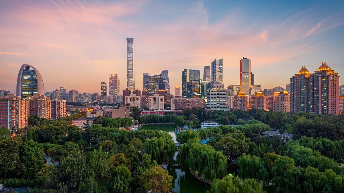 Beijing skyline silhouetted against a glowing sunset.