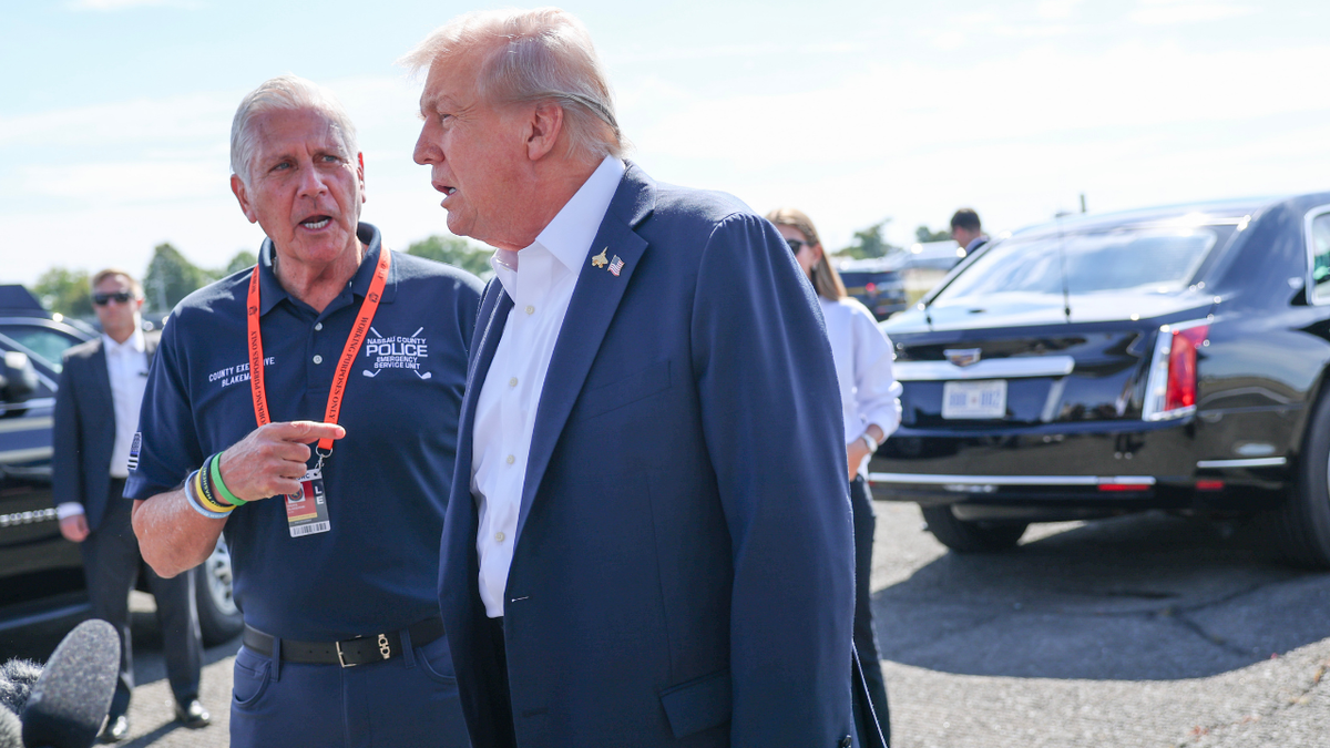 President Donald Trump is greeted by Bruce Blakeman, County Executive of Nassau County, New York, after arriving at the Republic Airport on Air Force One on September 26, 2025 in Farmingdale, New York.