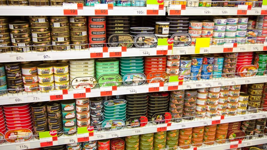 Canned fish on supermarket shelves.
