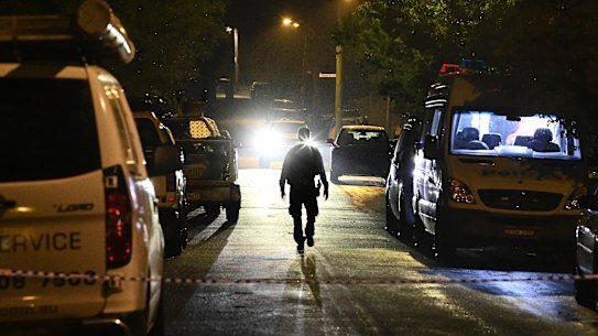 A police officer walks down the Campbelltown street on Monday night.