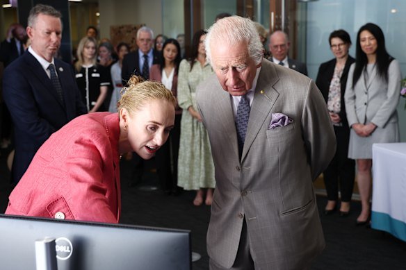 Britain’s King Charles is briefed by co-medical director Georgina Long as he visits the Melanoma Institute of Australia in Sydney in 2024.
