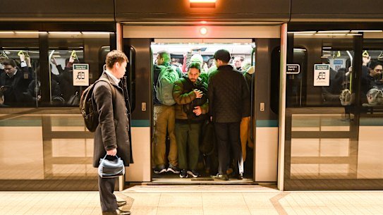 A commuter is left waiting for the next train at Crows Nest station because he cannot get on a packed service.