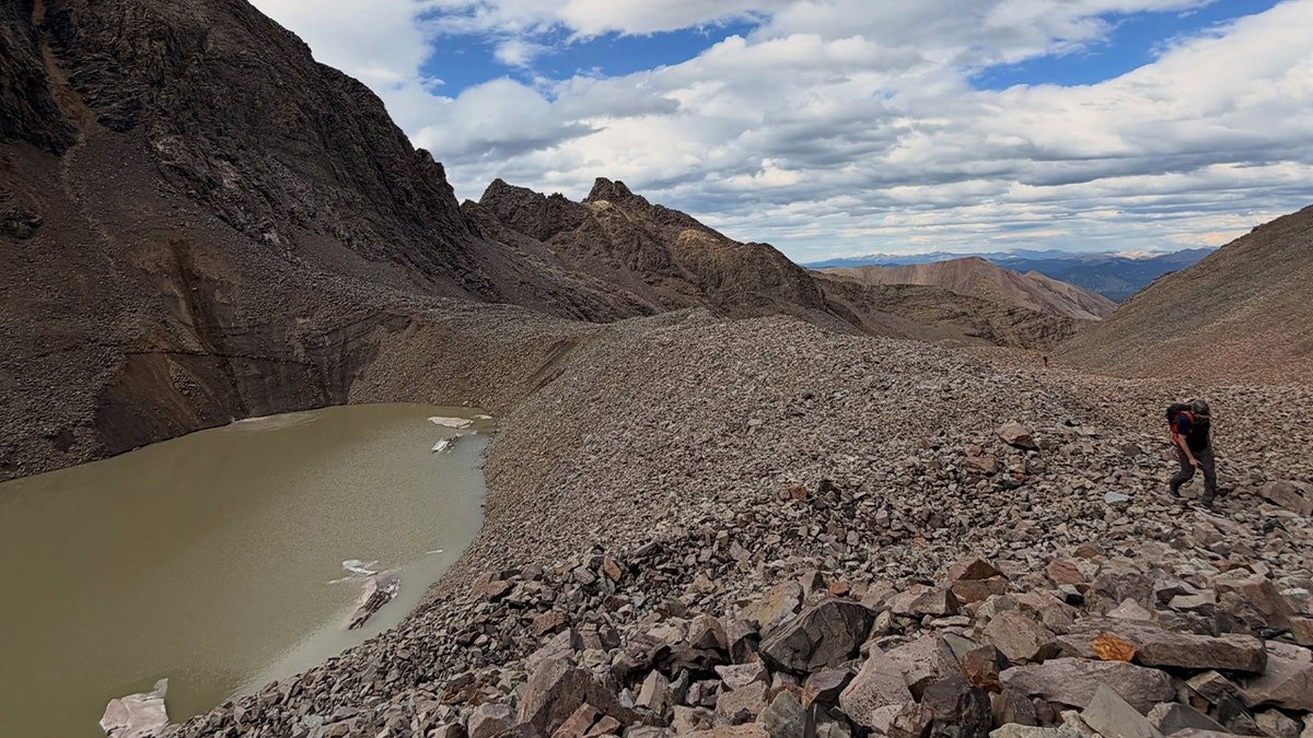 mountain range with nearby pond