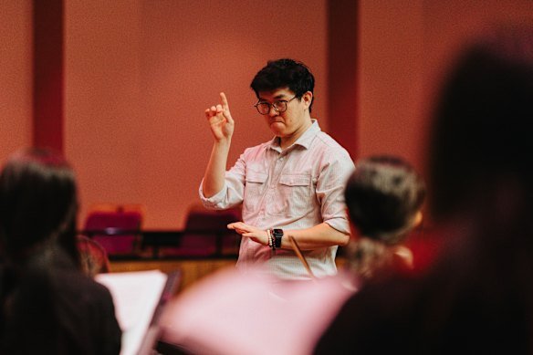 Fill-in choirmaster Zikang Zhan asks students to do it again, but in a different colour.