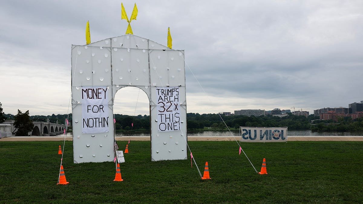 Demonstrators gather near Arlington Memorial Bridge to protest a proposed triumphal arch.