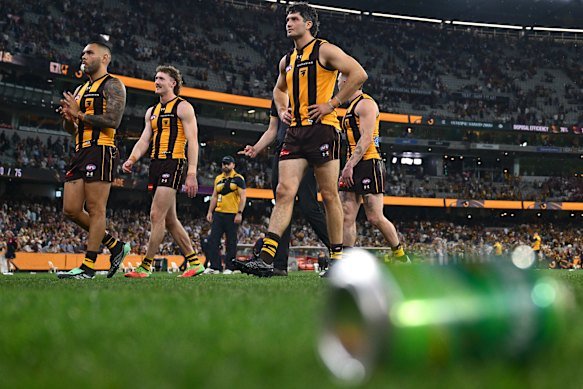 Cans litter the ground after Hawthorn’s loss to Brisbane.