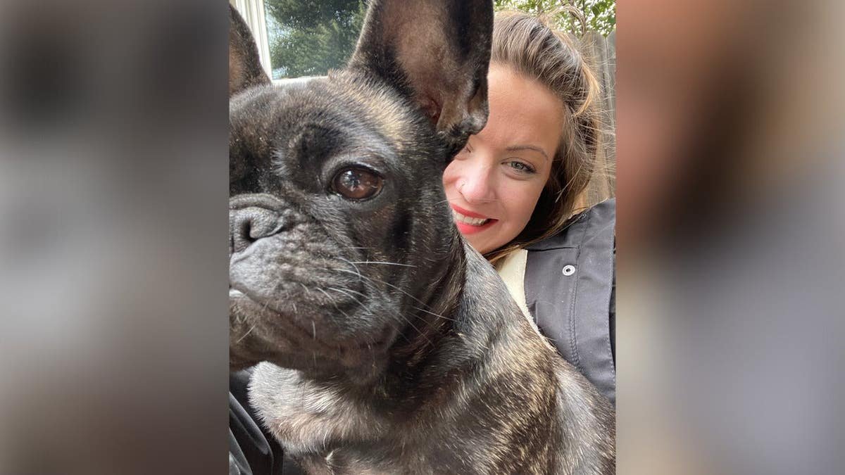 Mallory Wilson smiling in selfie with dog, Cassie