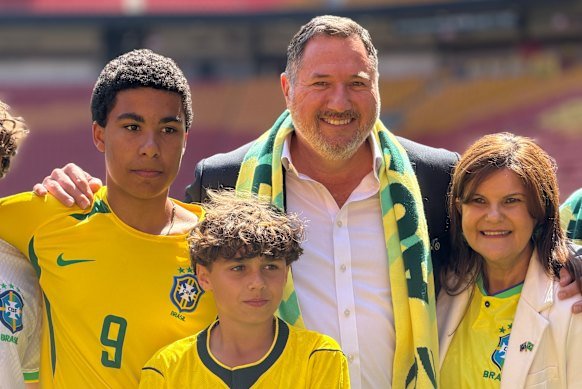 Tourism Minister Andrew Powell and Australia-Brazil Chamber of Commerce chief executive Valeria Noleto with Brazilian fans at Suncorp Stadium on Wednesday morning.