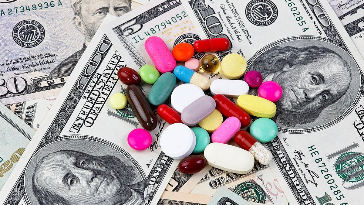 An image of a pile of pills on top of a stack of money