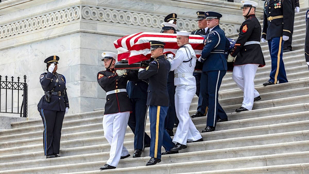 Hershel Woodrow Williams' coffin is carried down Capitol steps during a ceremony in Washington, D.C.