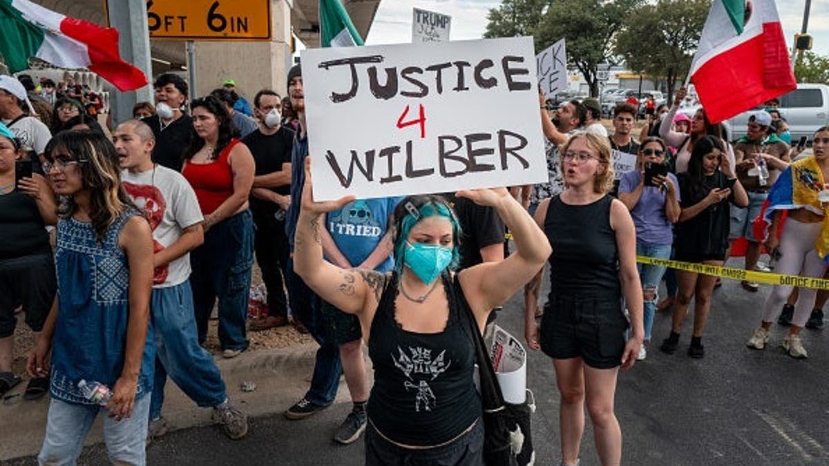 People protest against ICE officers in Austin, Texas.