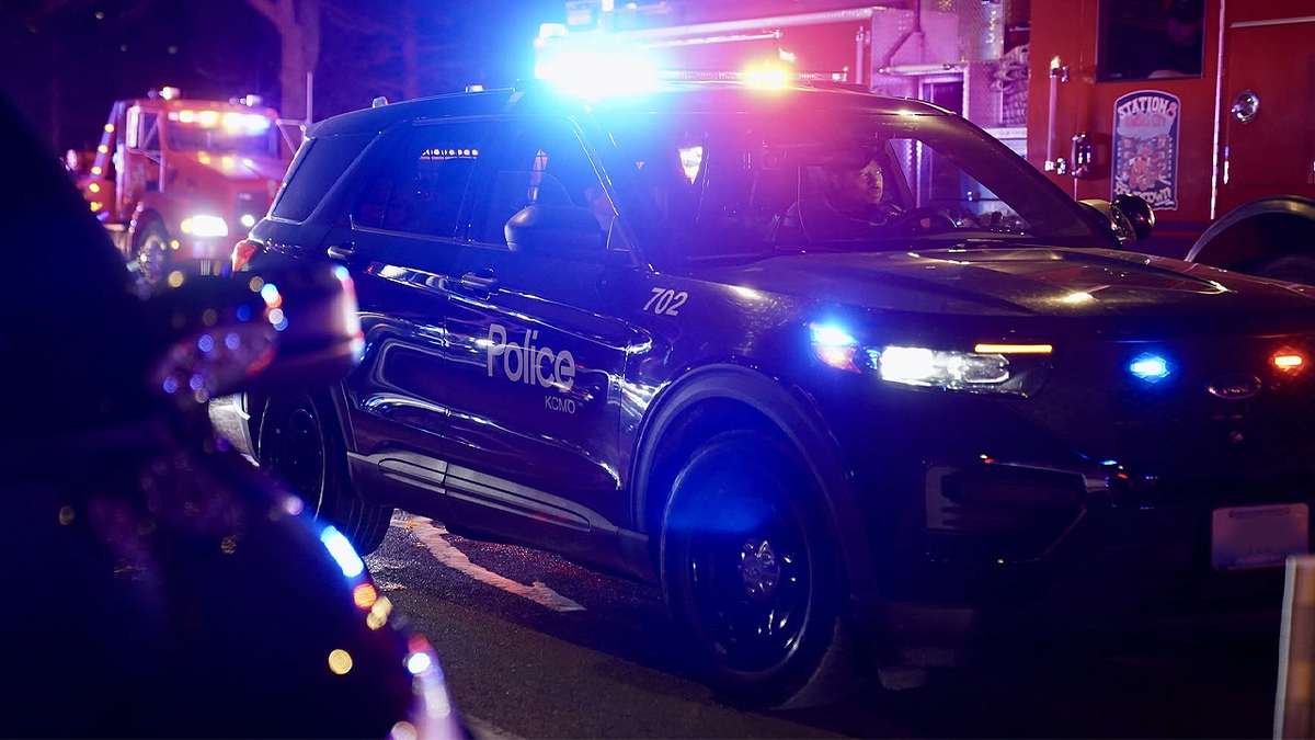 Kansas City, Missouri, police patrol vehicle with emergency lights flashing at night