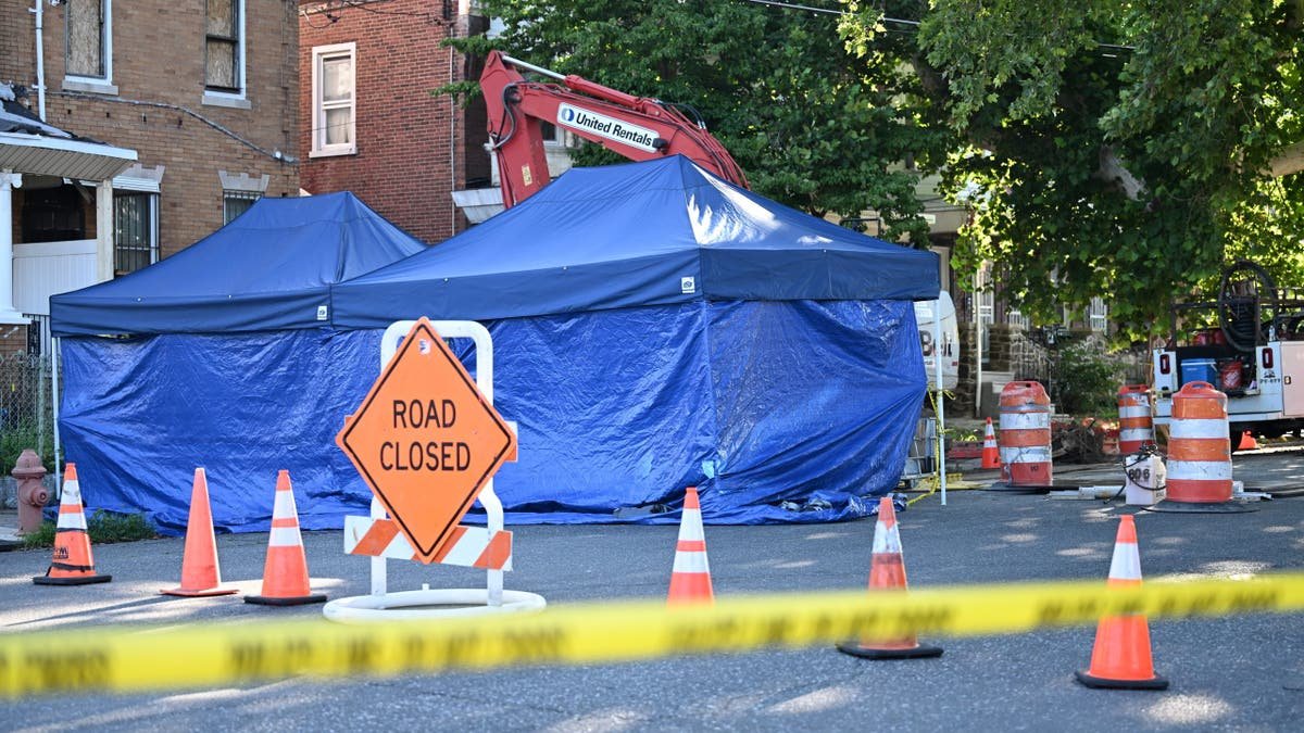 Eugene Horsch's home in Philadelphia's Olney neighborhood as law enforcement officers and utility crews excavate.