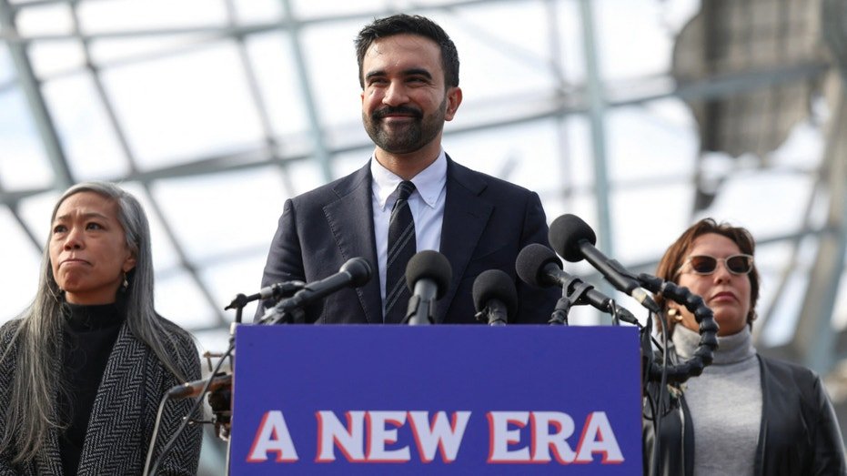 New York City Mayor-elect Zohran Mamdani speaks at a podium.